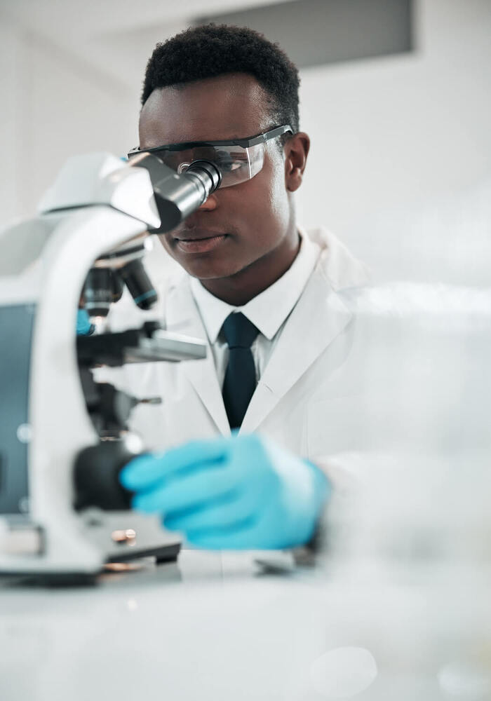 person looking through microscope
